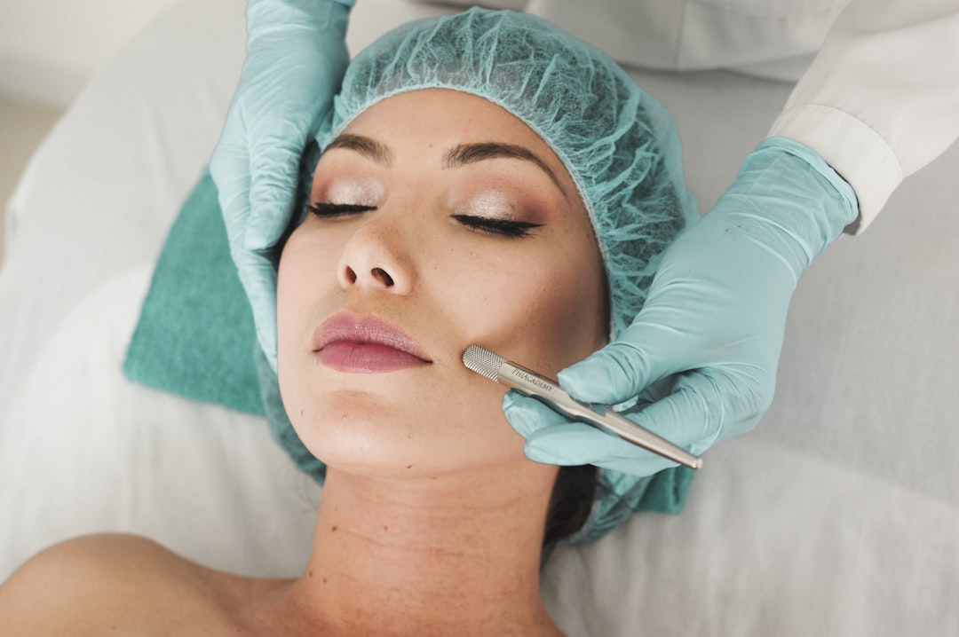 woman doing liposuction on her face - Photo by karelys Ruiz on Unsplash